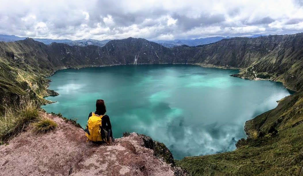 hiker admiring Quilotoa crater lake