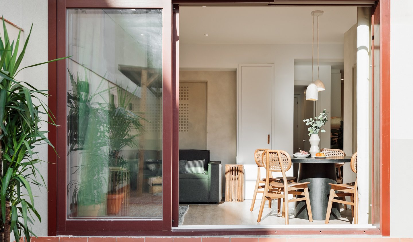 Modern dining area and terrace with sleek design elements and natural wood accents
