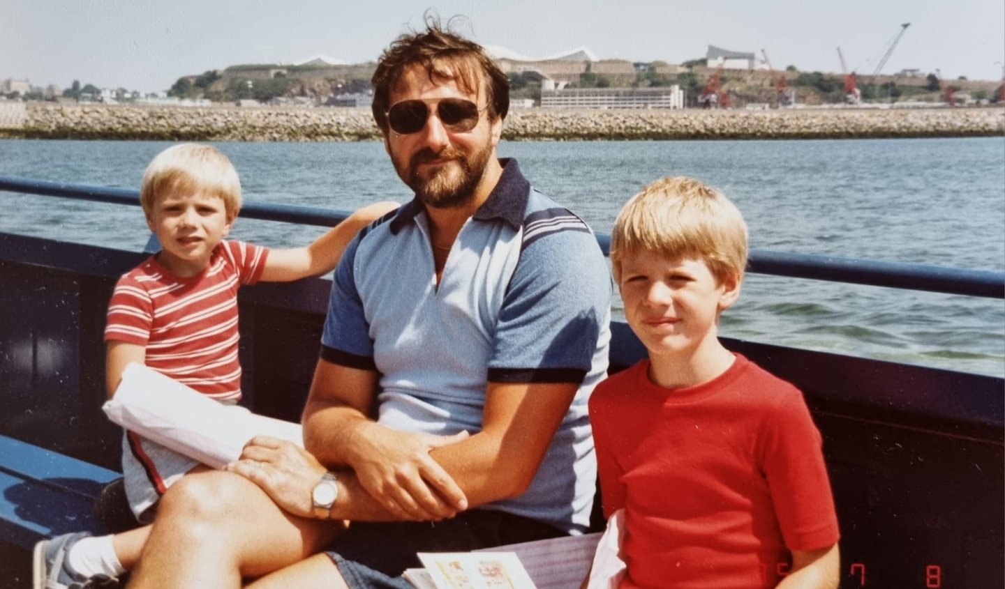 photo of my brother, Dad and me on a boat on a beautiful sunny day
