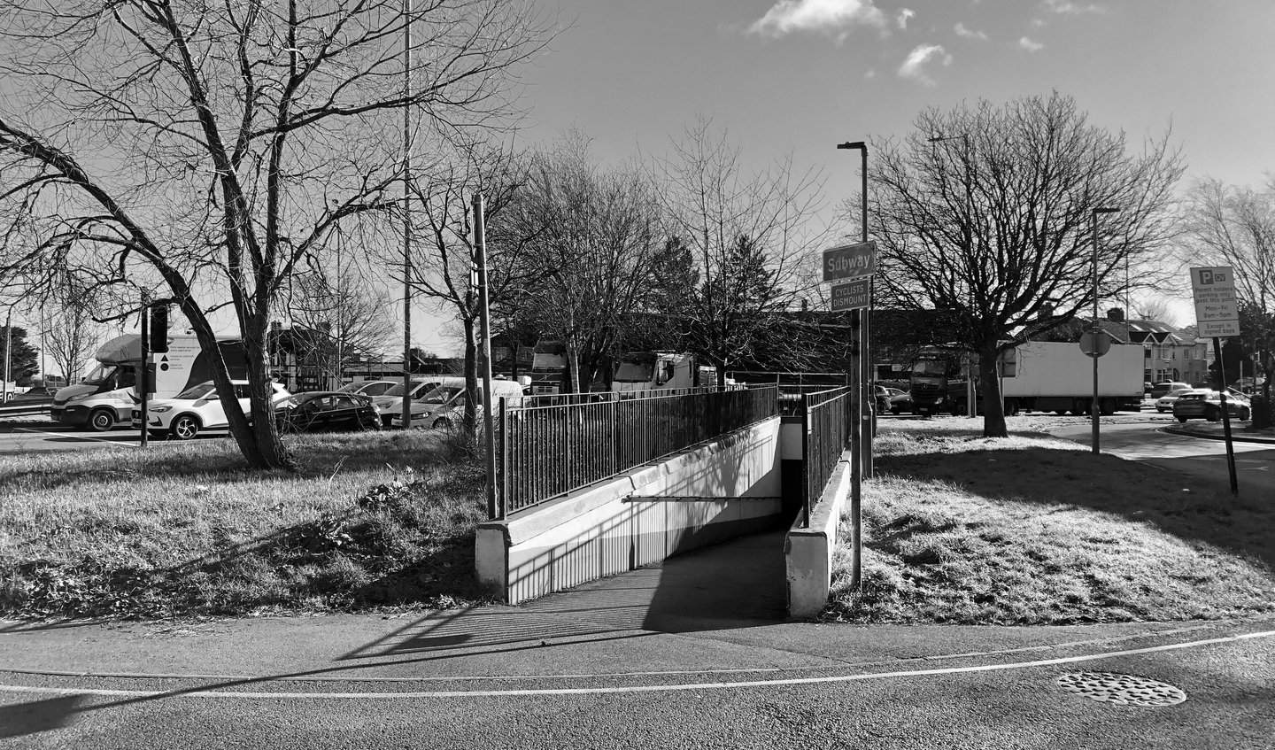 a black and white photo of an entrance to a pedestrian tunnel
