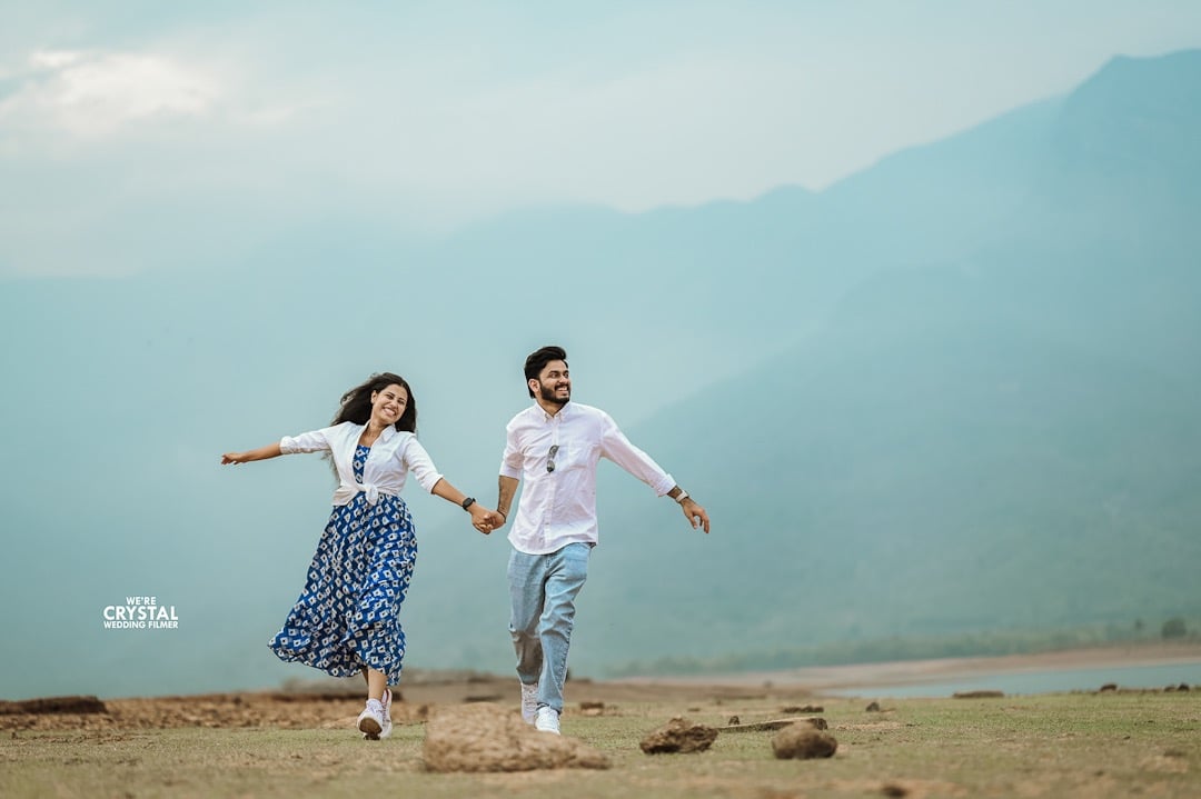 Couple holding hands and running during Pre wedding photography on golden hour