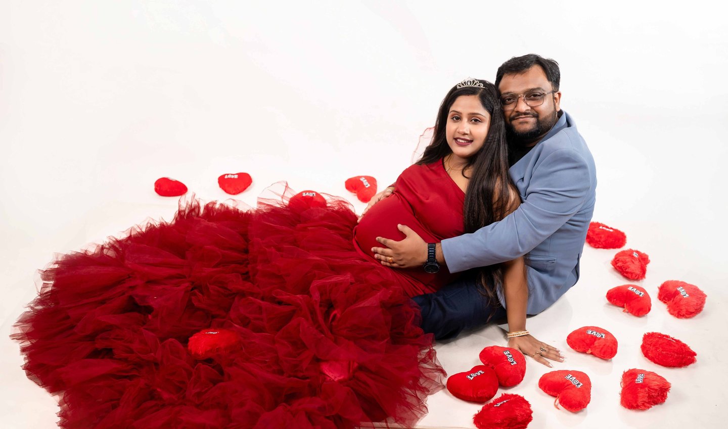 Romantic maternity portrait of parents-to-be at home