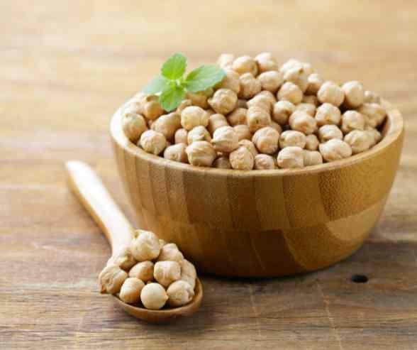 wooden bowl of raw chickpeas