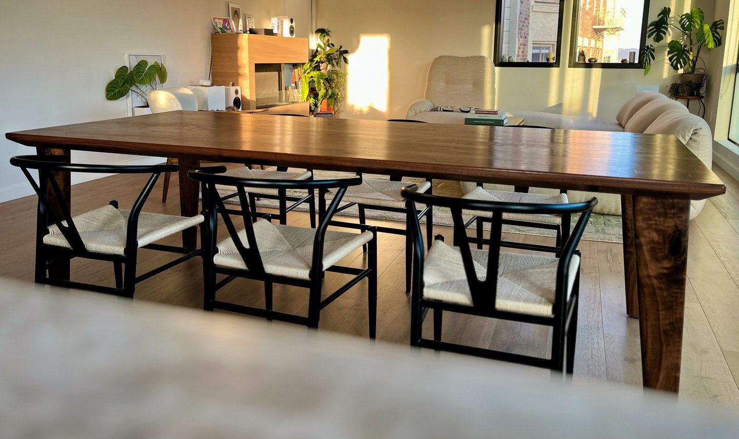 Handcrafted walnut dining table with sculpted legs and