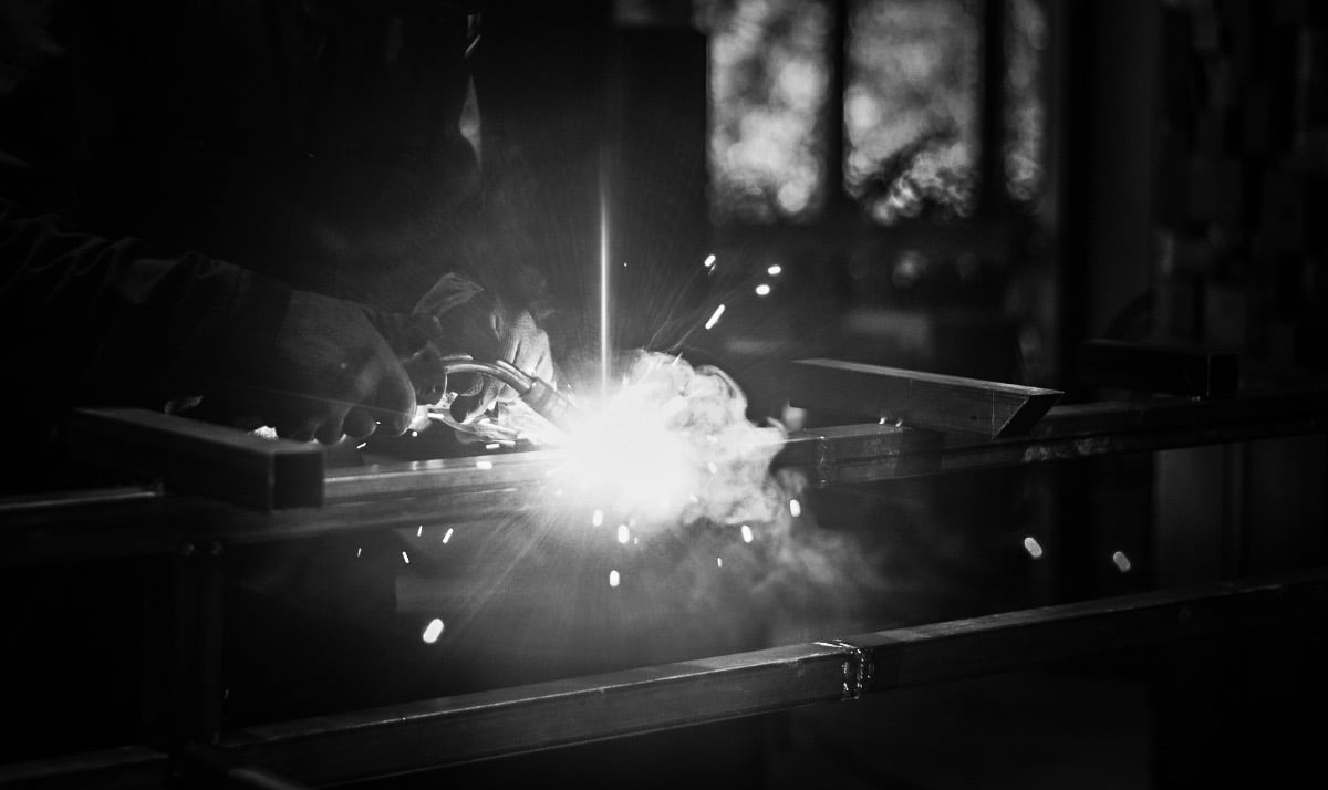 a person welding a metal object in a dark room