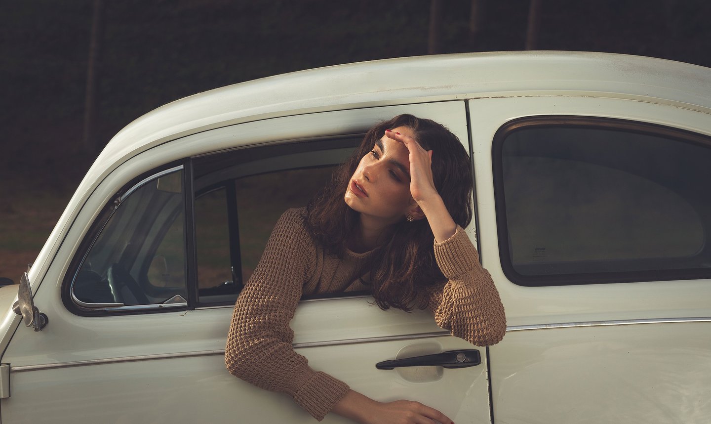 a woman leaning out of a car window