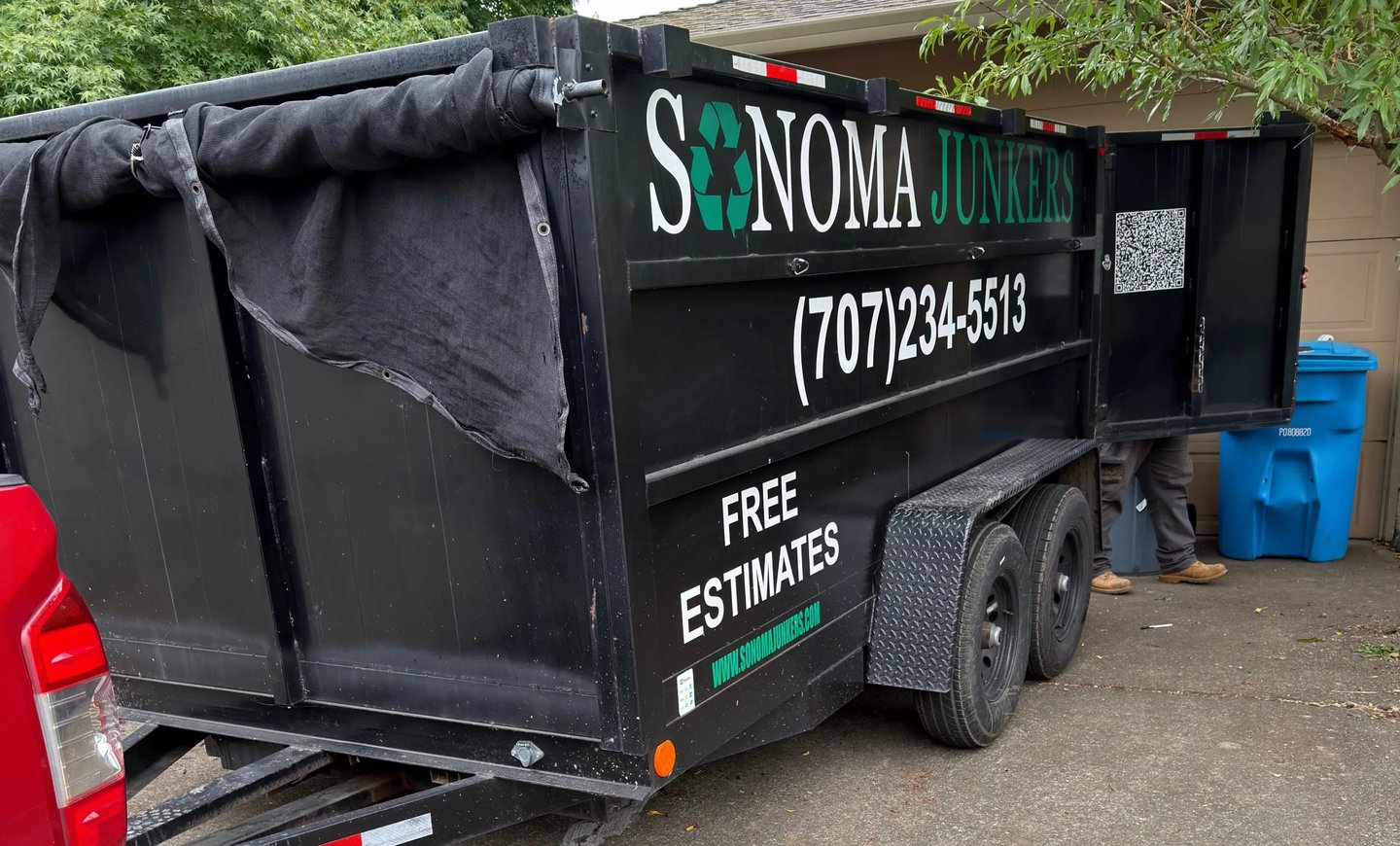 Sonoma Junkers trailer backed up to a garage with the doors open