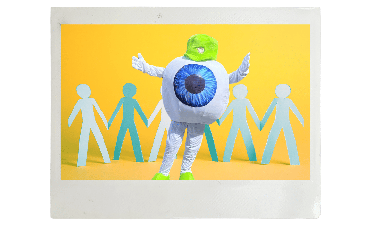 Edge Optics' eyeball mascot standing in front of people cutouts