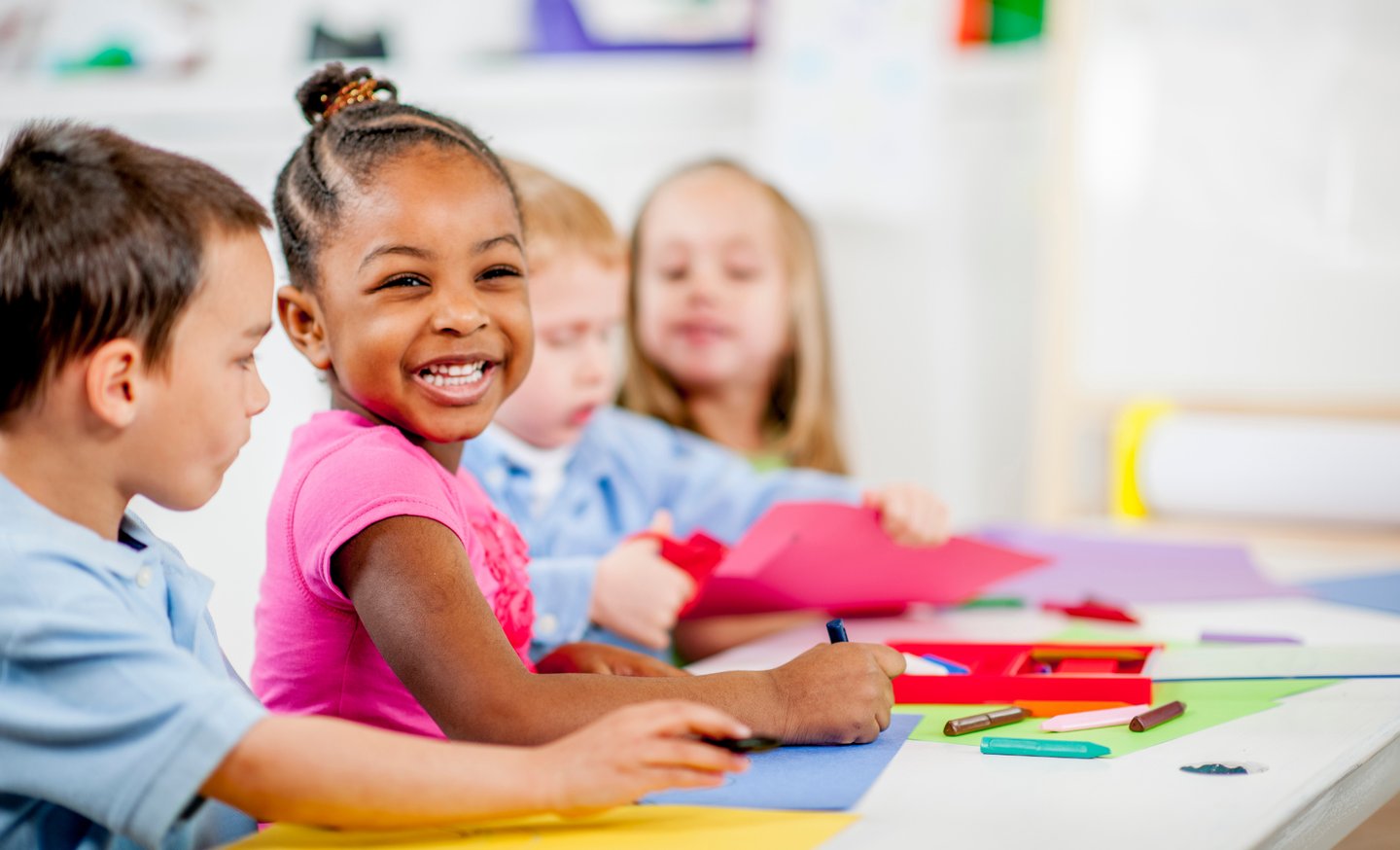 Children smiling and coloring