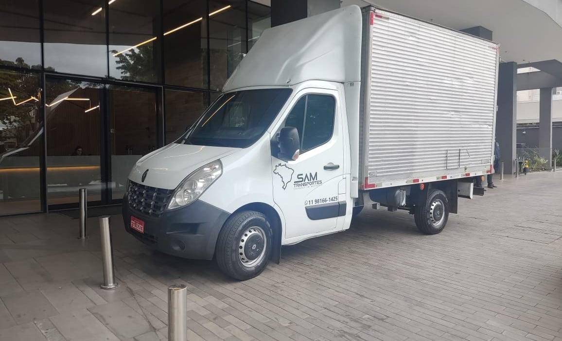 a truck with a white truck parked in front of a building