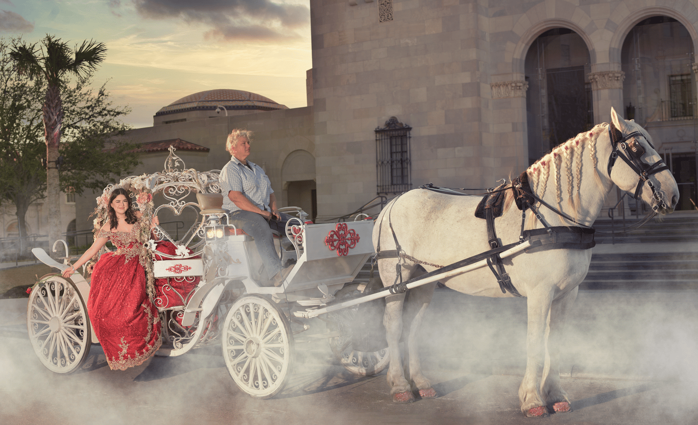 a man and quinceanera in a carriage drawn carriage