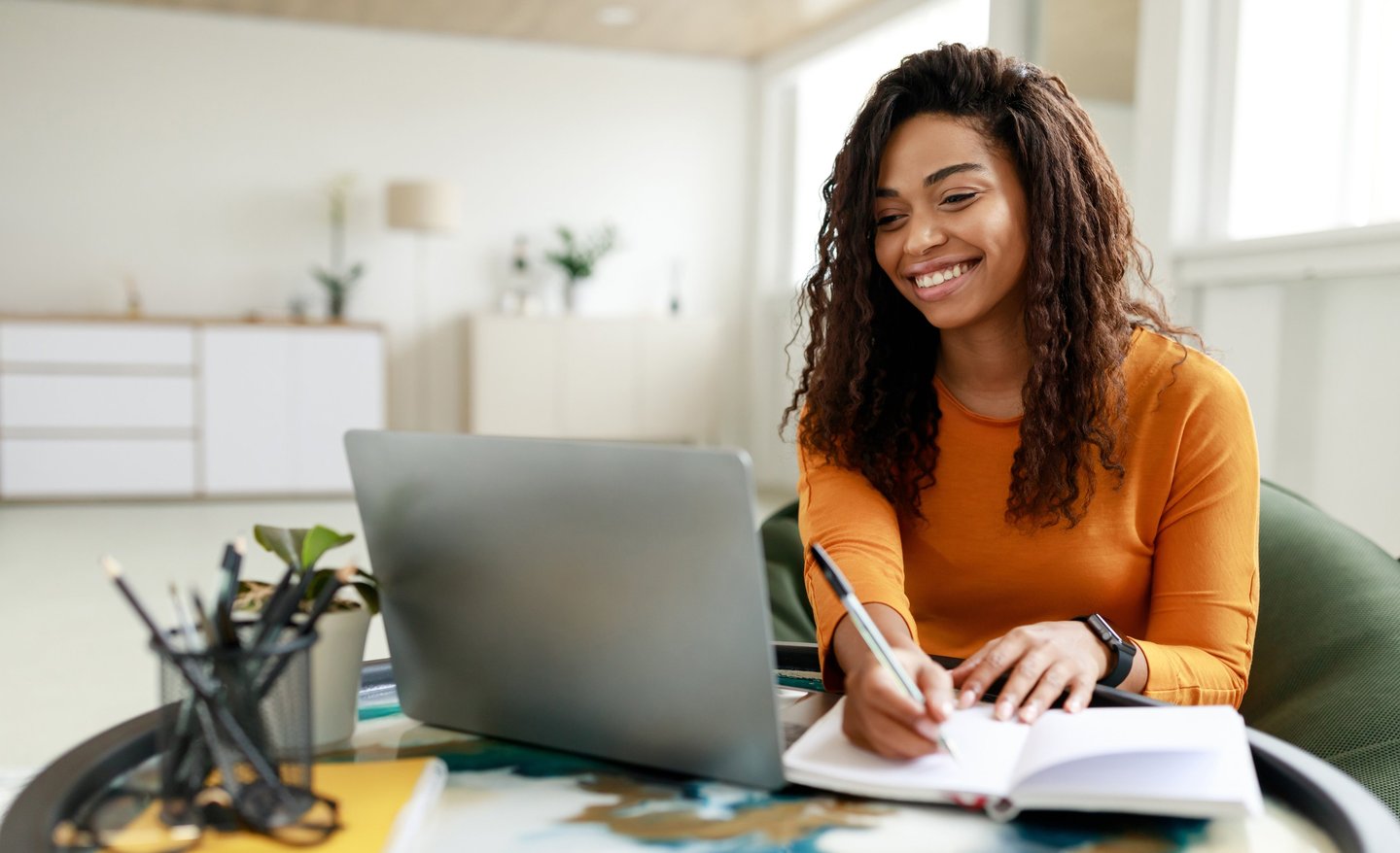 Woman smiles as she speaks to mediator on her laptop
