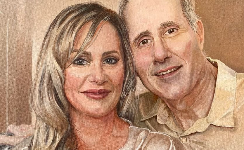 A hand-painted portrait of a happily smiling couple in a serene rose and taupe colour scheme.