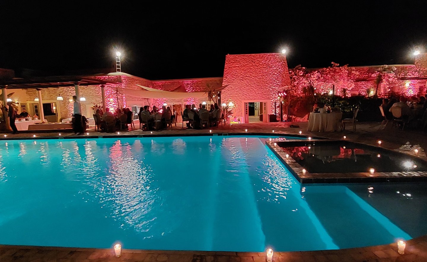 a pool with candles and candles on the side of it