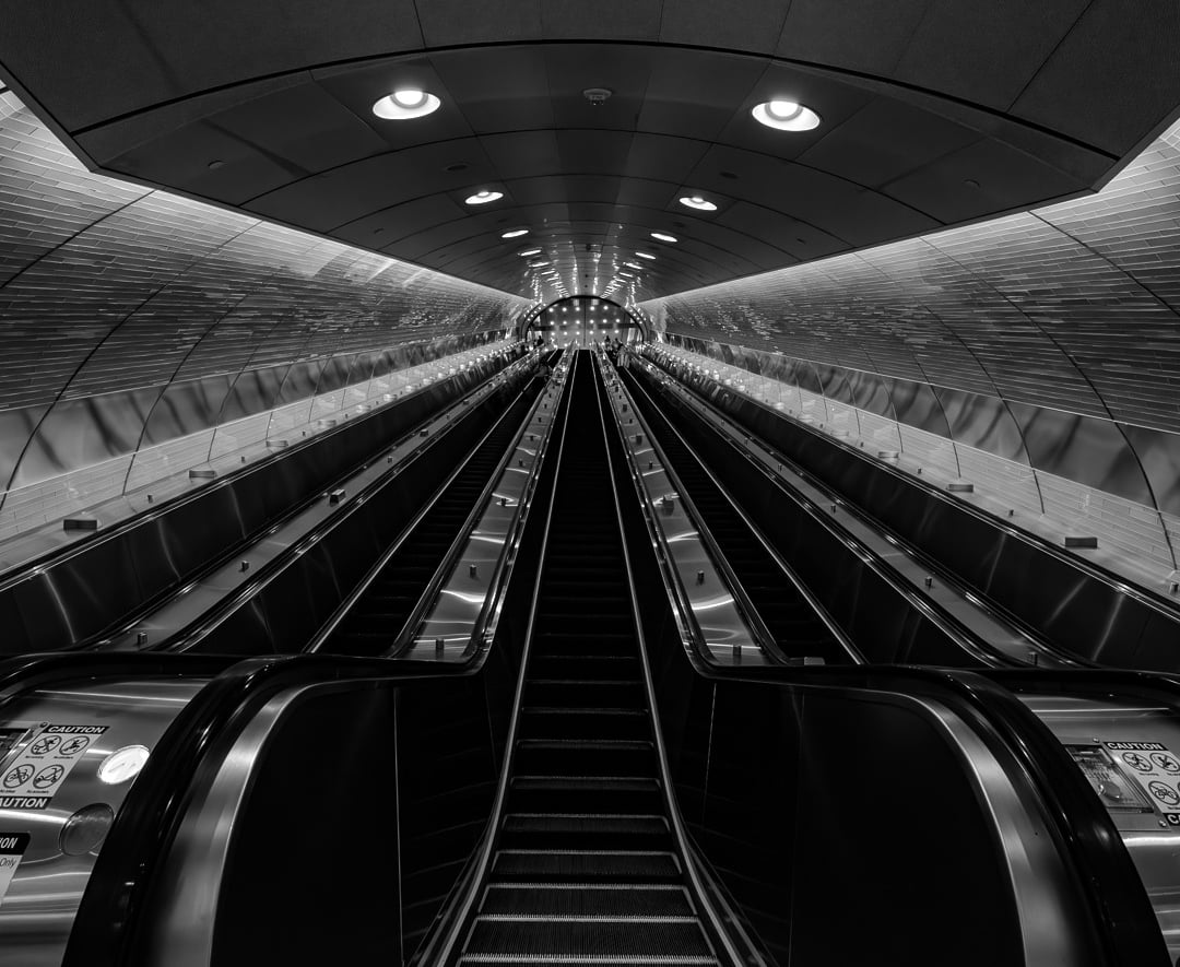 black and white photo of the escalators in grand central terminal