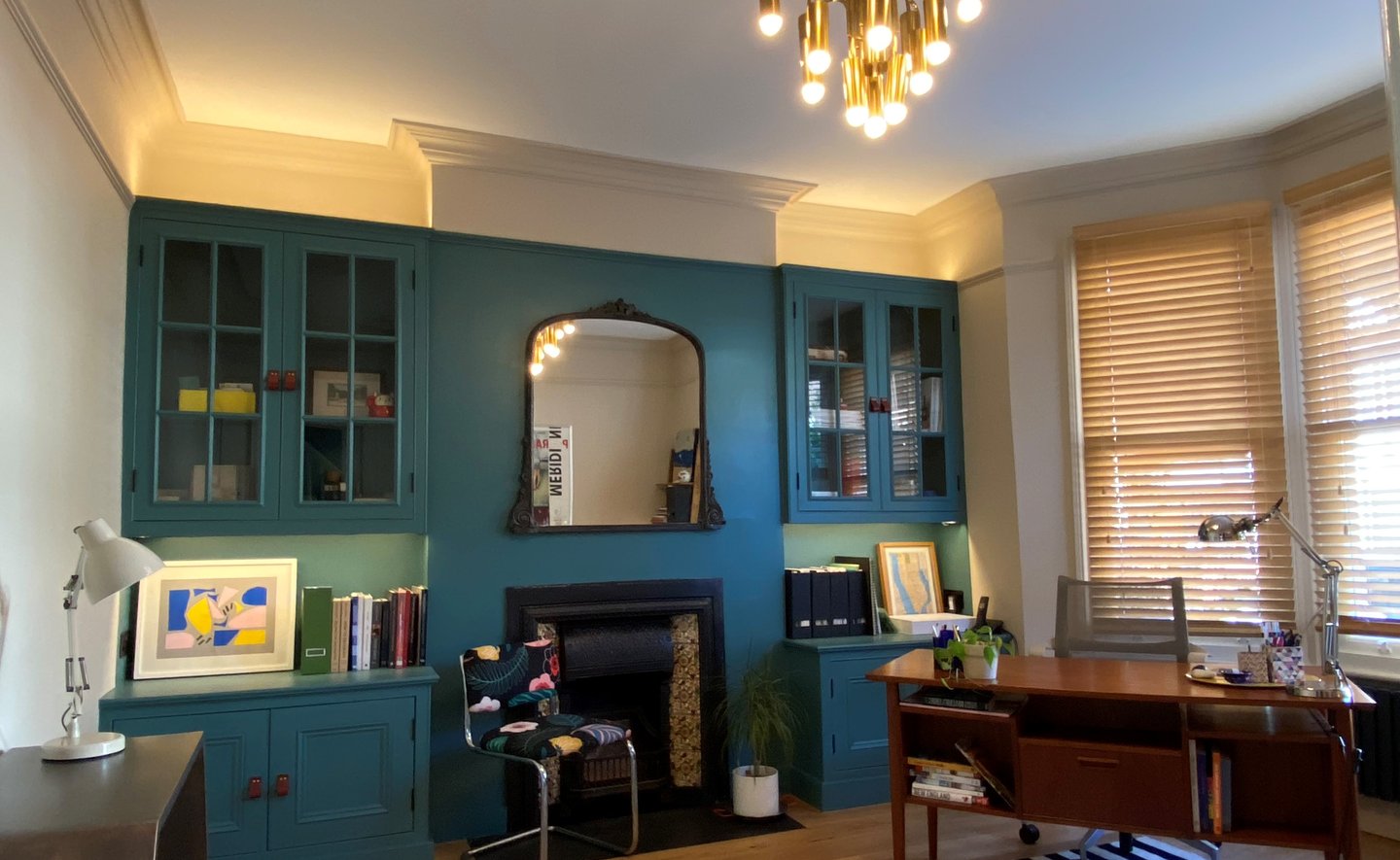 Home office layered lighting. Glow above and below cabinets lights up the space softly