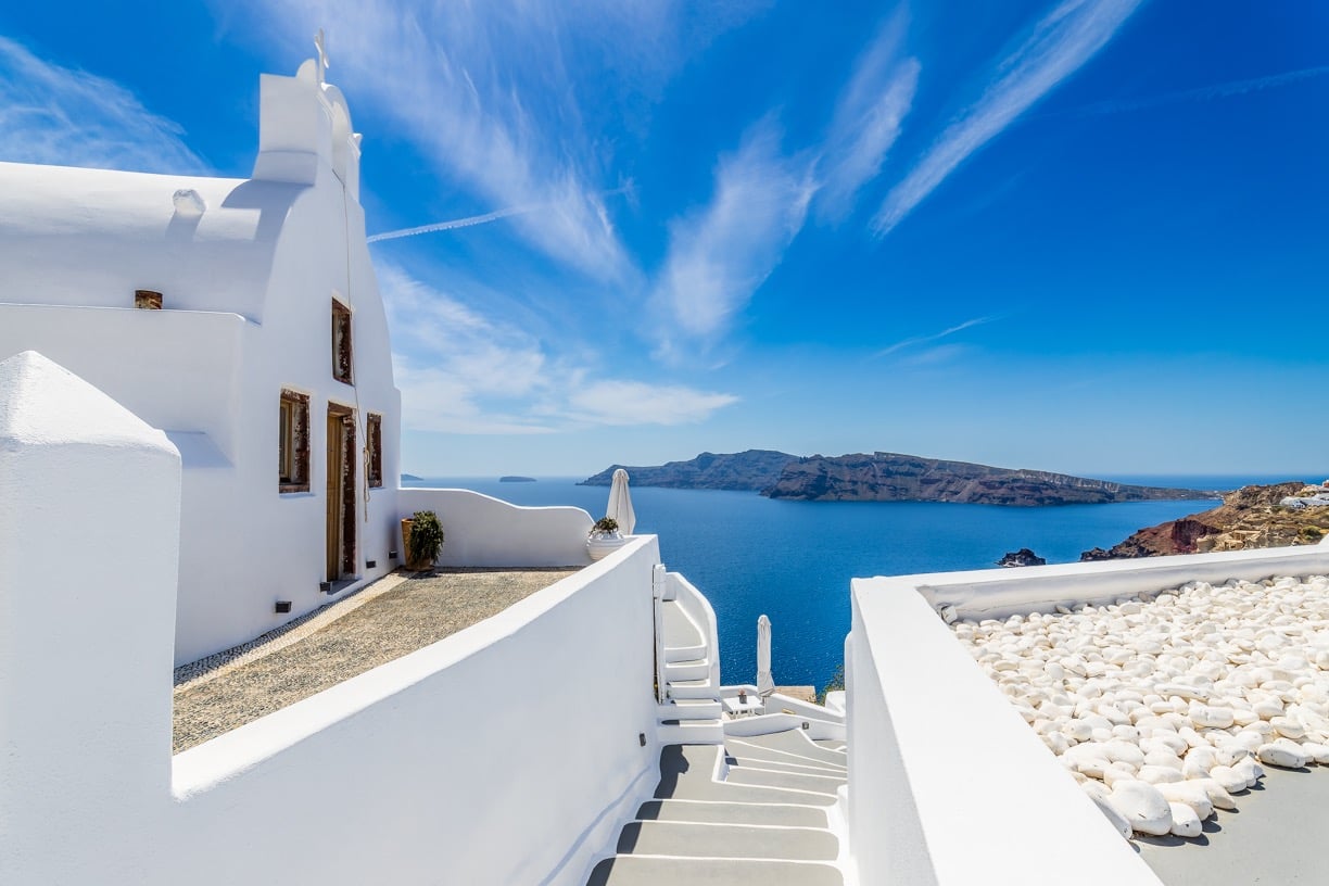 Santorin, Greece a white house with a view of the sea