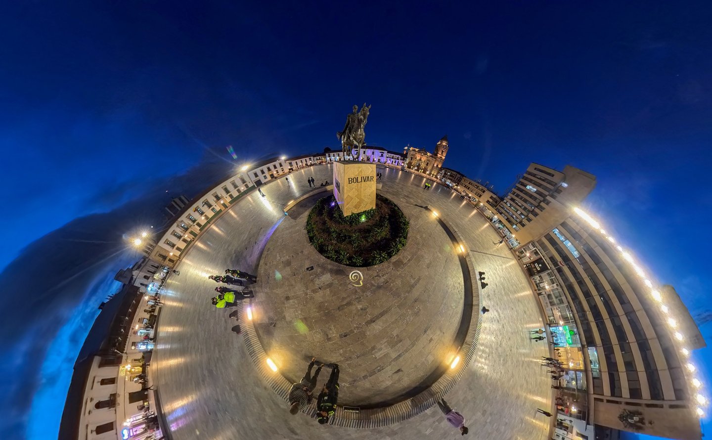 Panoramic 360 view of Plaza de Bolivar in Tunja, Colombia at night with the equestrian statue.
