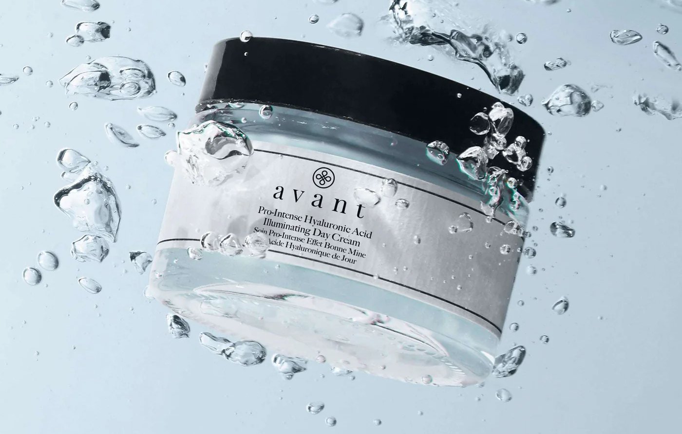 Avant Pro-Intense Hyaluronic Acid Illuminating Day Cream jar submerged in clear water with bubbles.