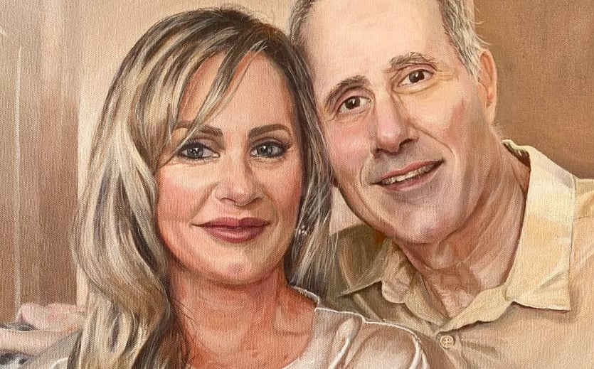 A hand-painted portrait of a happily smiling couple in a serene rose and taupe colour scheme.