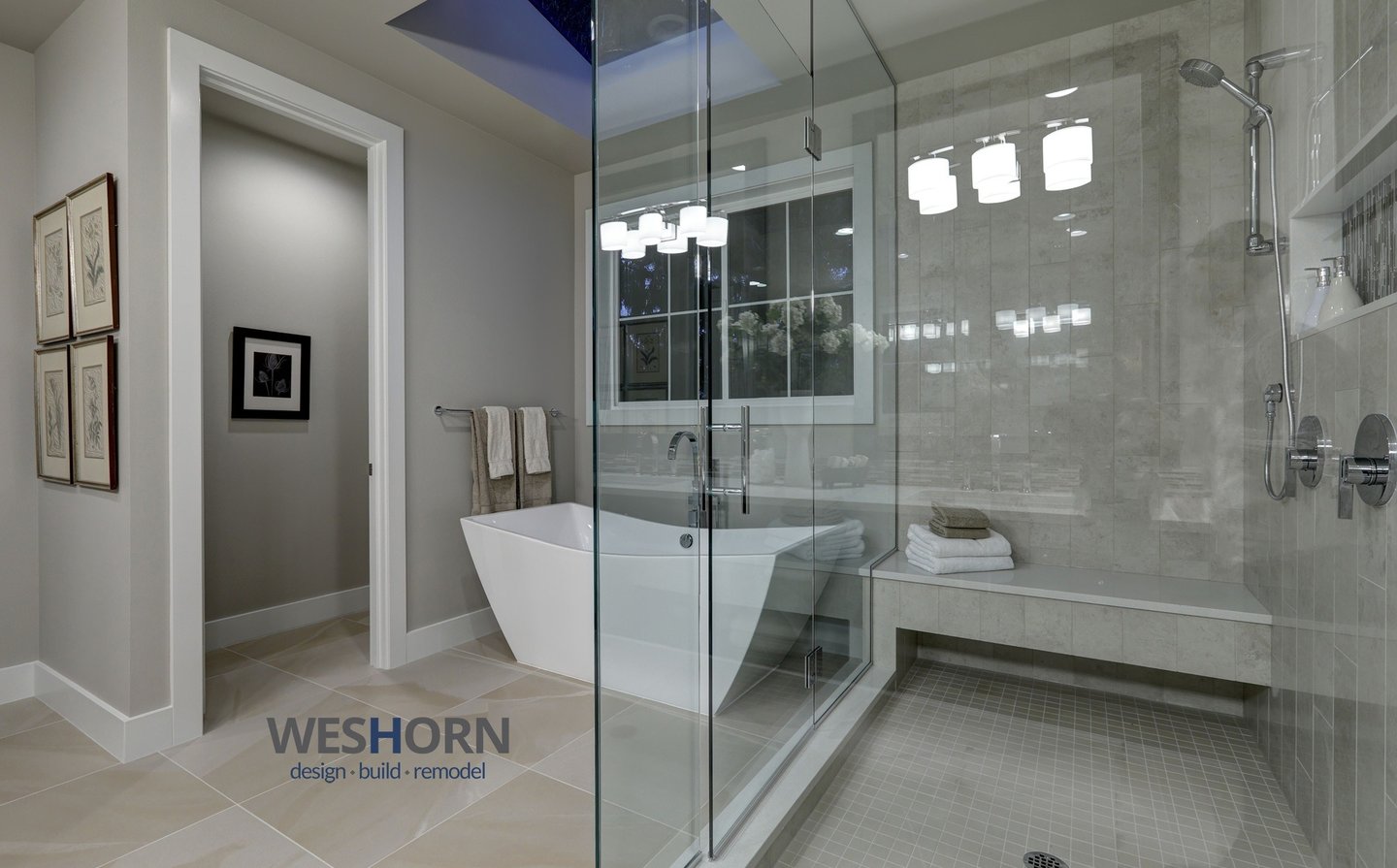 Modern luxury bathroom featuring a freestanding soaking tub and glass walk-in shower with stone tile.