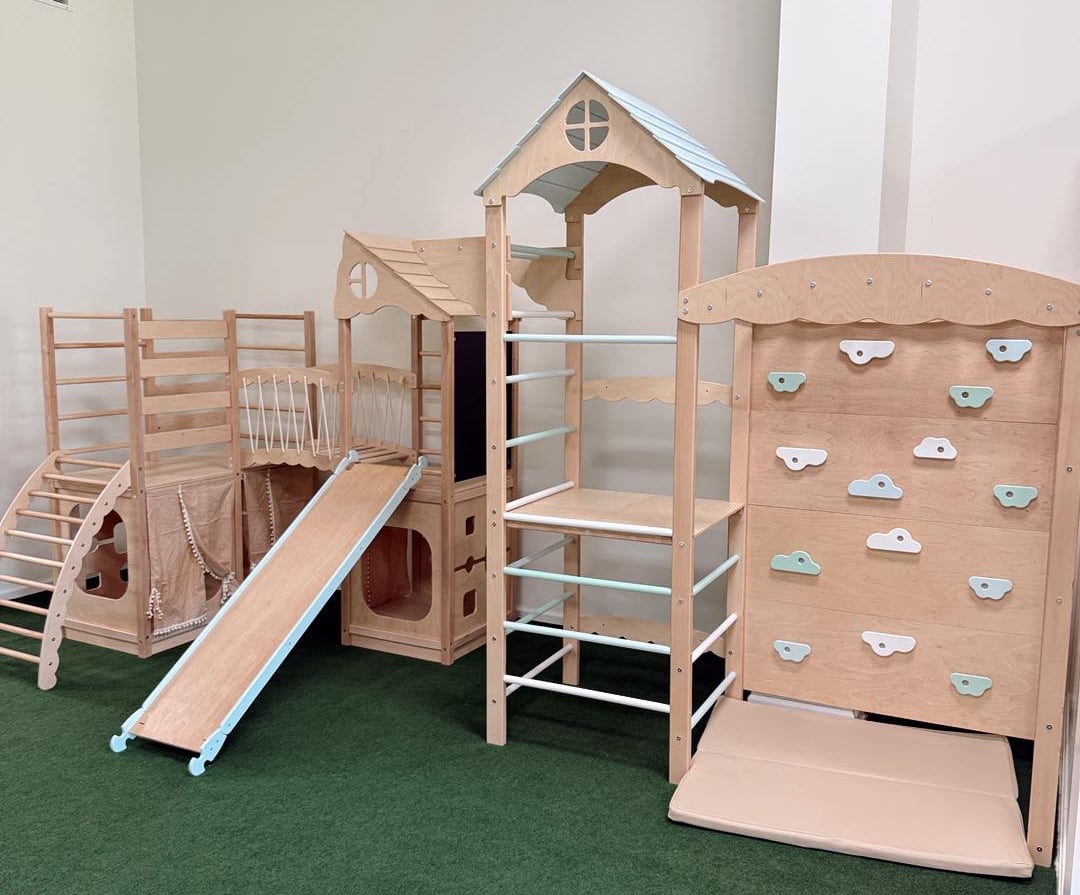 a play area with a wooden play structure