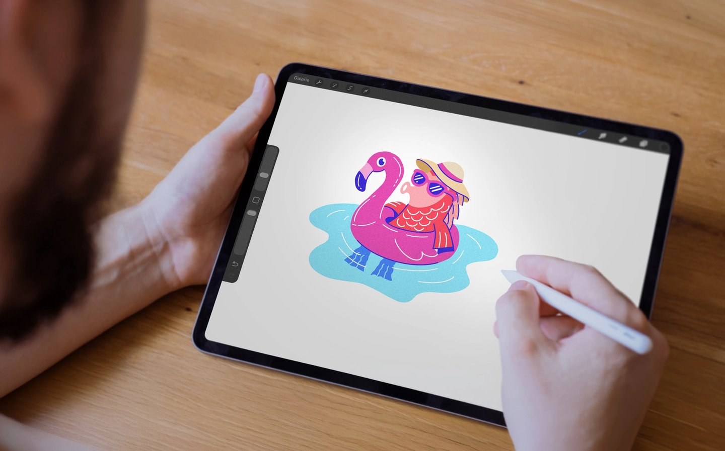 Man drawing an individual koi sketch on a tablet as part of the design process
