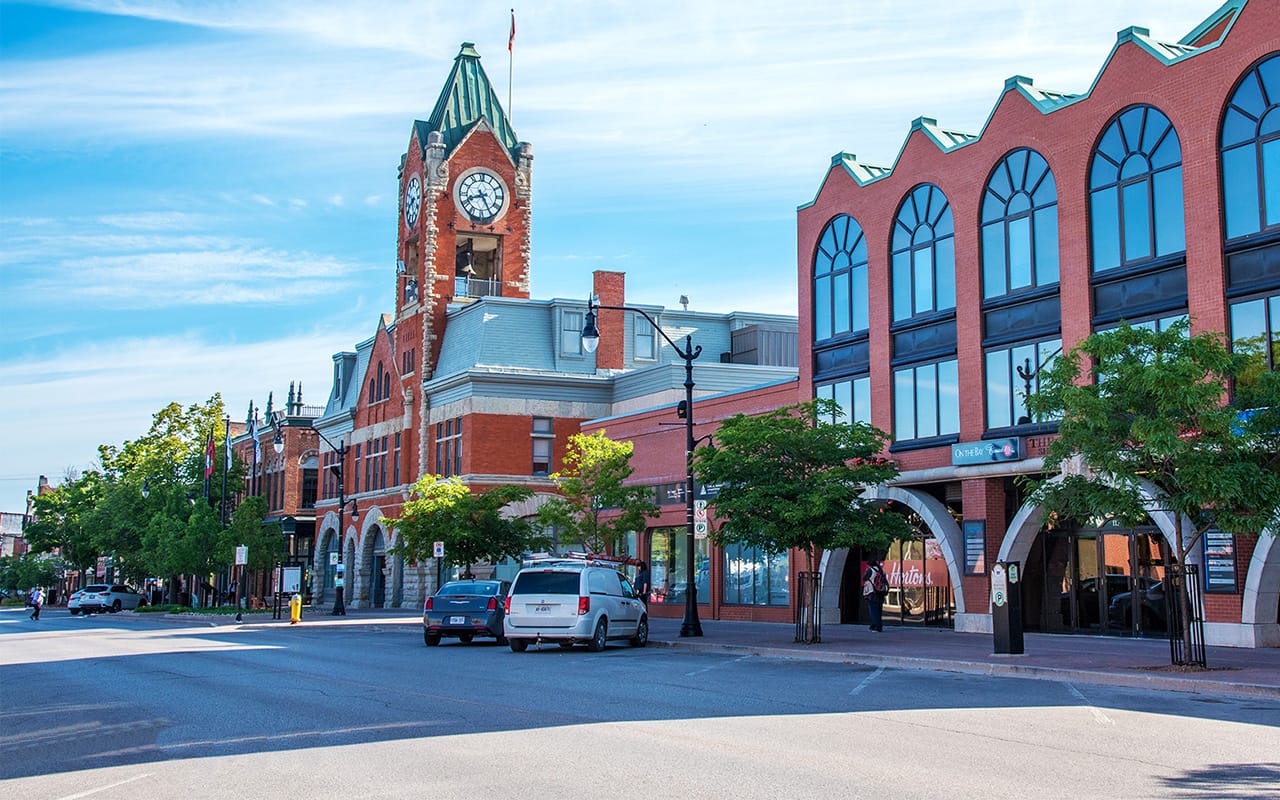 Outdoor view of a building with a prominent clock tower under a clear sky