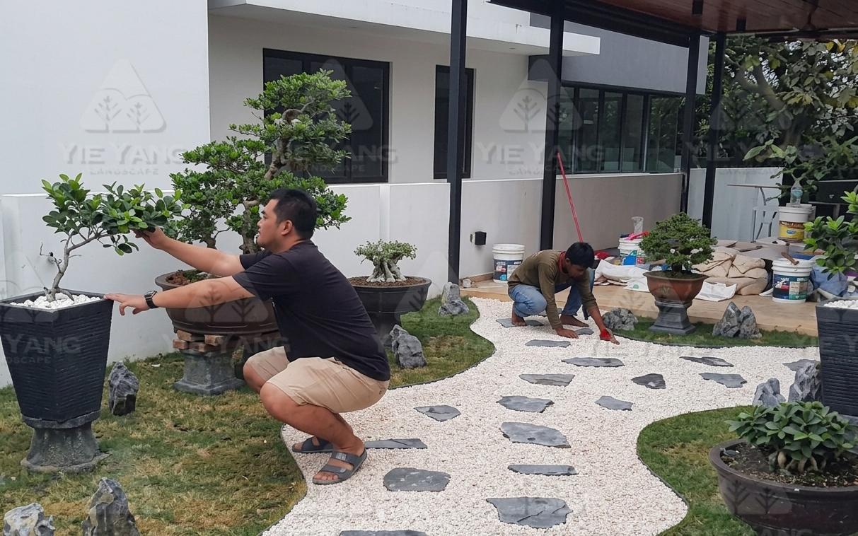 Bonsai garden installation at Laman Granview Selangor featuring potted trees and white gravel path.
