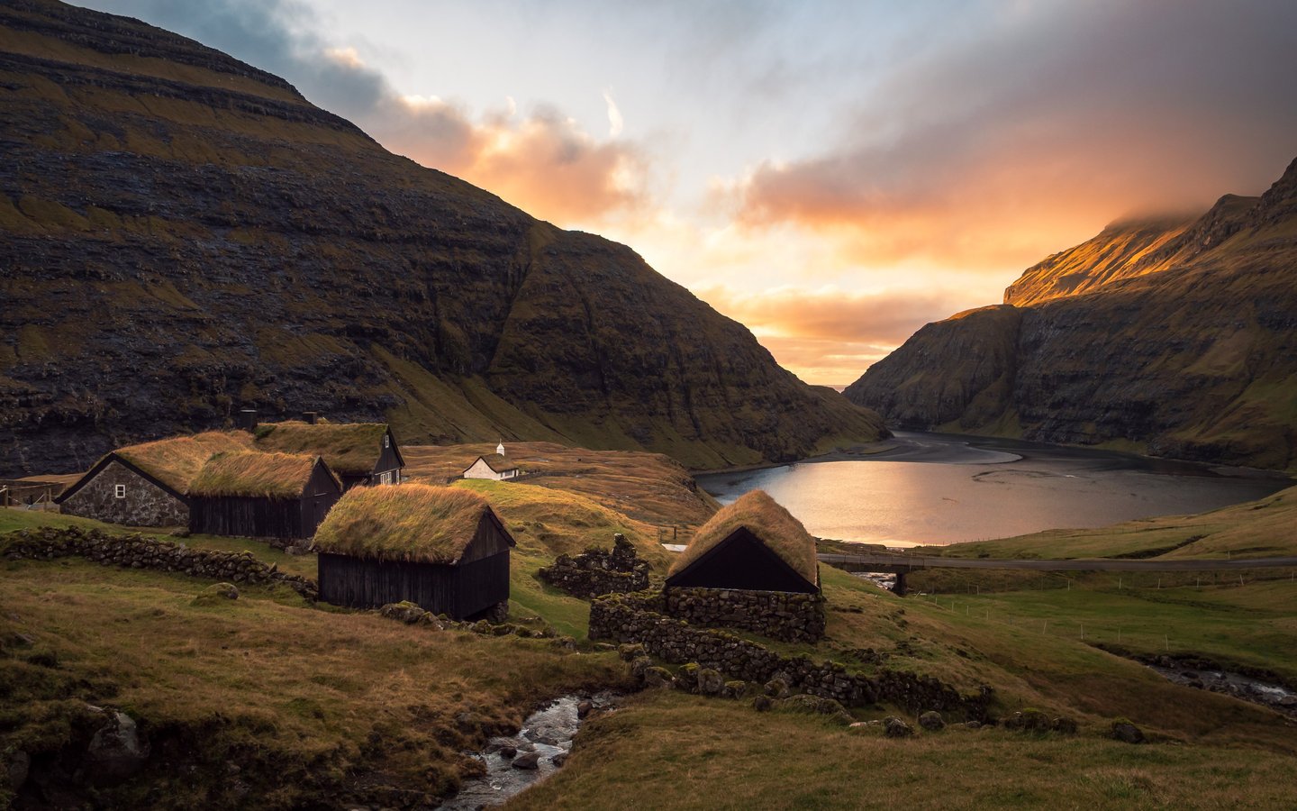 Saksun village at sunset – turf-roof houses and golden light on the lagoon in the Faroe Islands