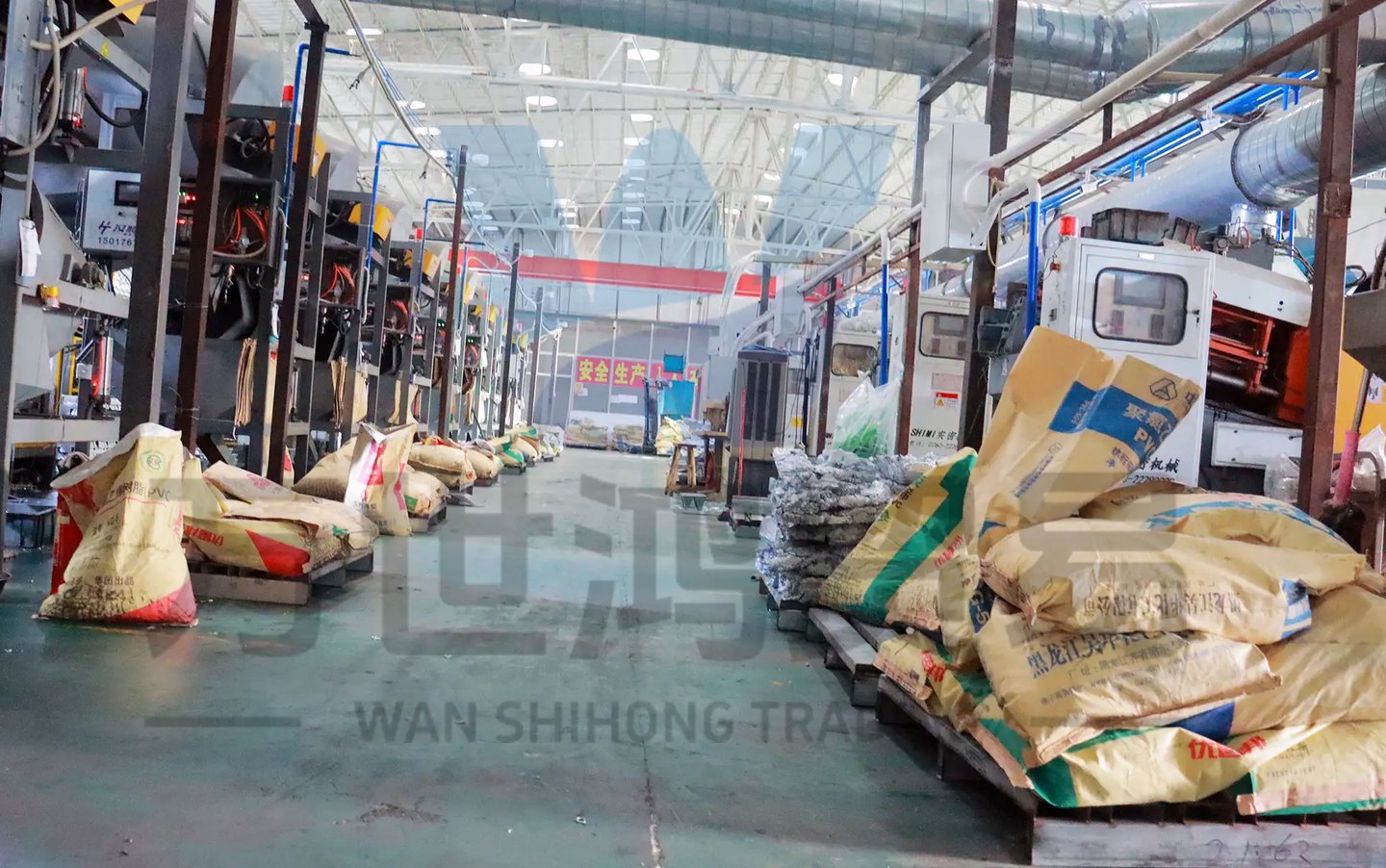 In the workshop of the bag and luggage accessories factory, rows of machines and raw materials for p