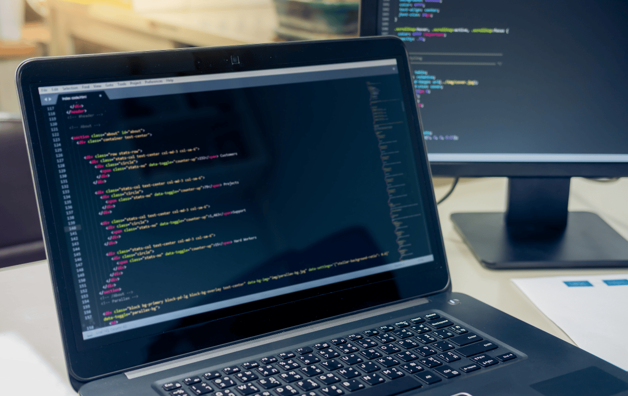 a laptop displaying HTML code