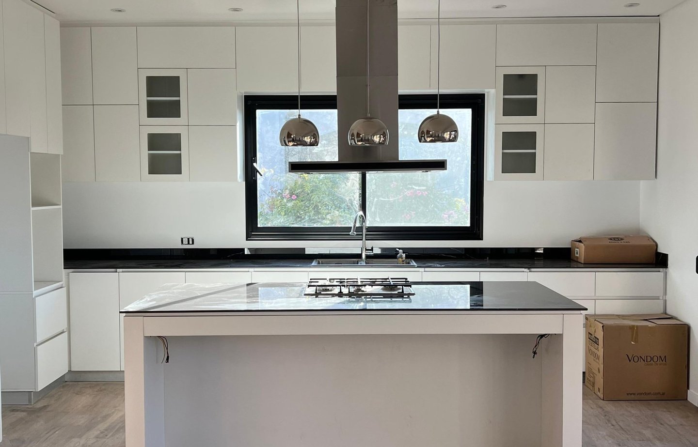 a kitchen with a large island and a large window