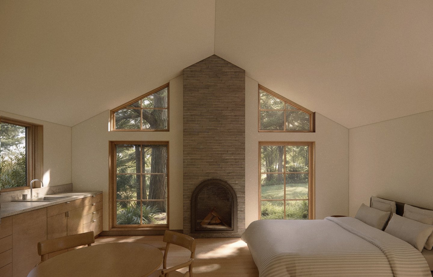 Modern minimalist studio with a stone fireplace, vaulted ceiling, and forest view windows.