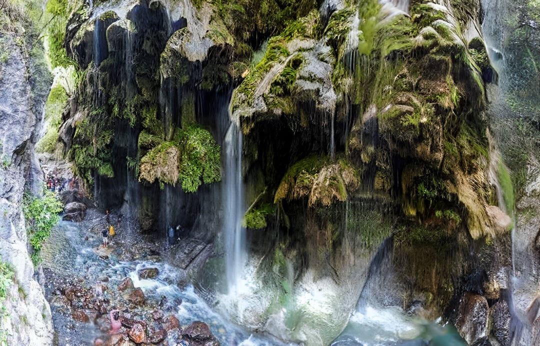 Umbrella waterfall in a canyon with a waterfall in the background