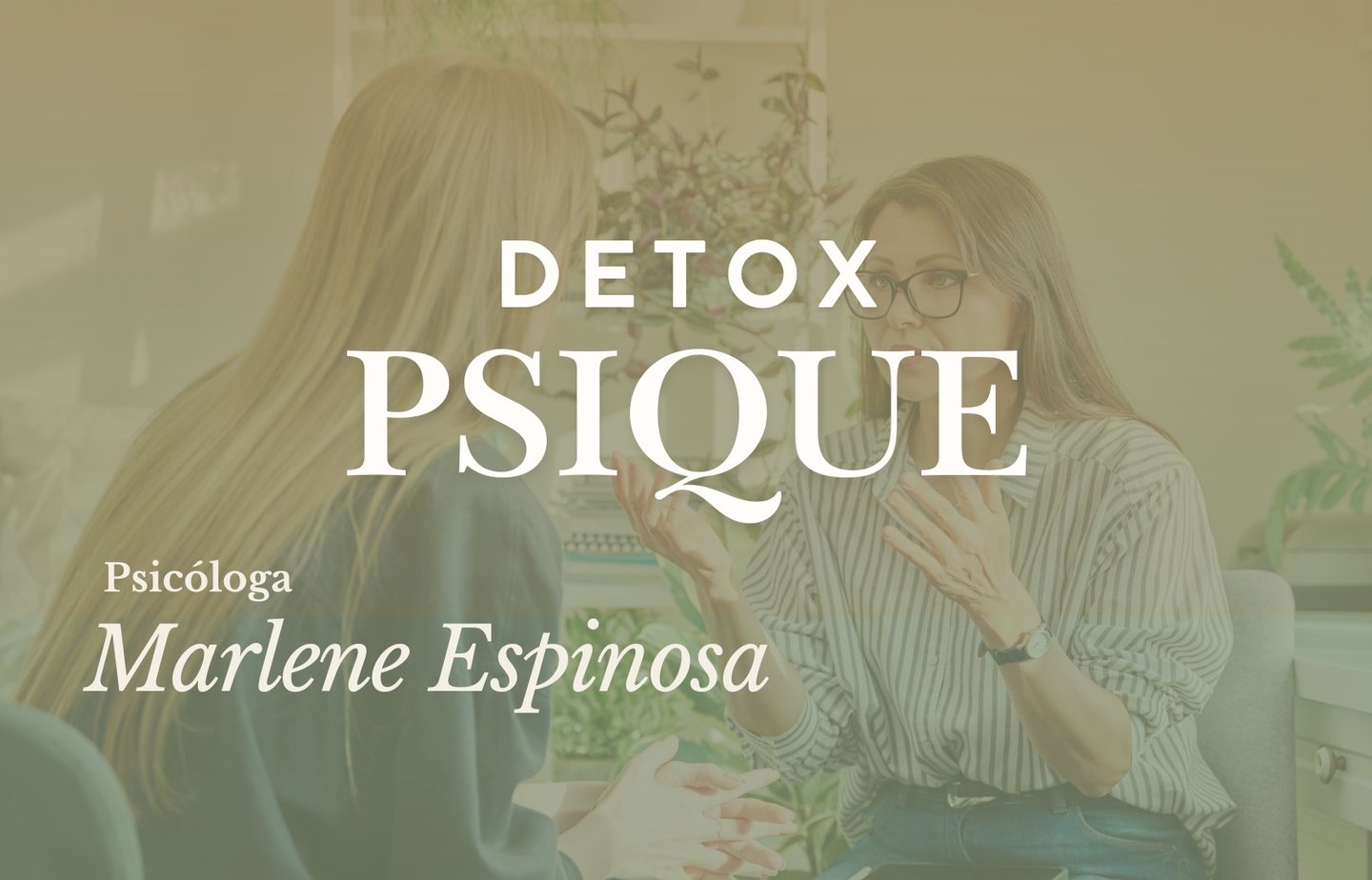 a woman in a striped shirt and glasses sitting at a desk