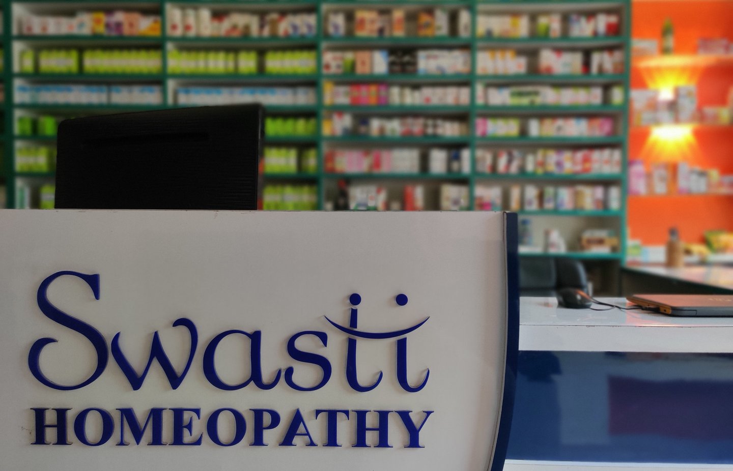 a woman in a white shirt is standing in front of a counter