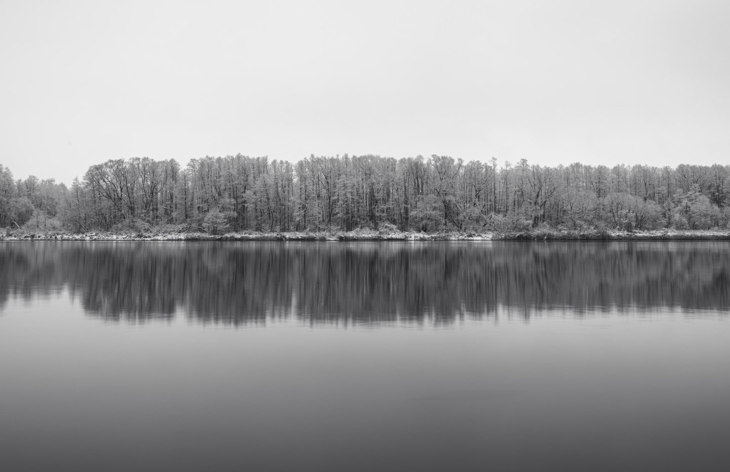 Landscape photography, snowy trees reflection in water. Birštonas, Lithuania.