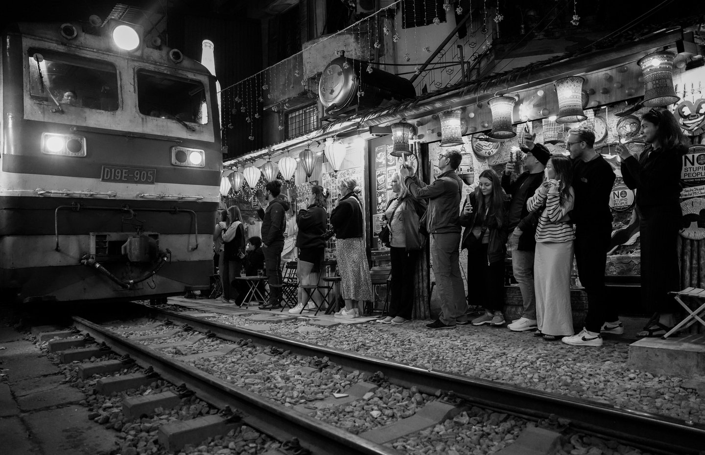 Hanoi Train Street black and white night photography train passing narrow street