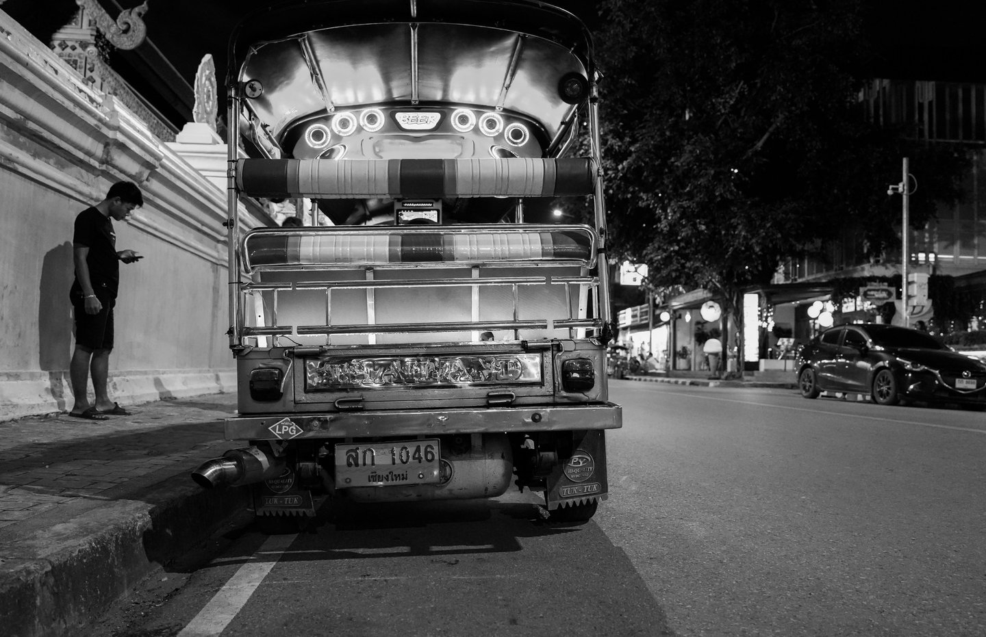 Atmosphere of a street in Chiang Mai, Thailand, including TuK Tuk Taxi