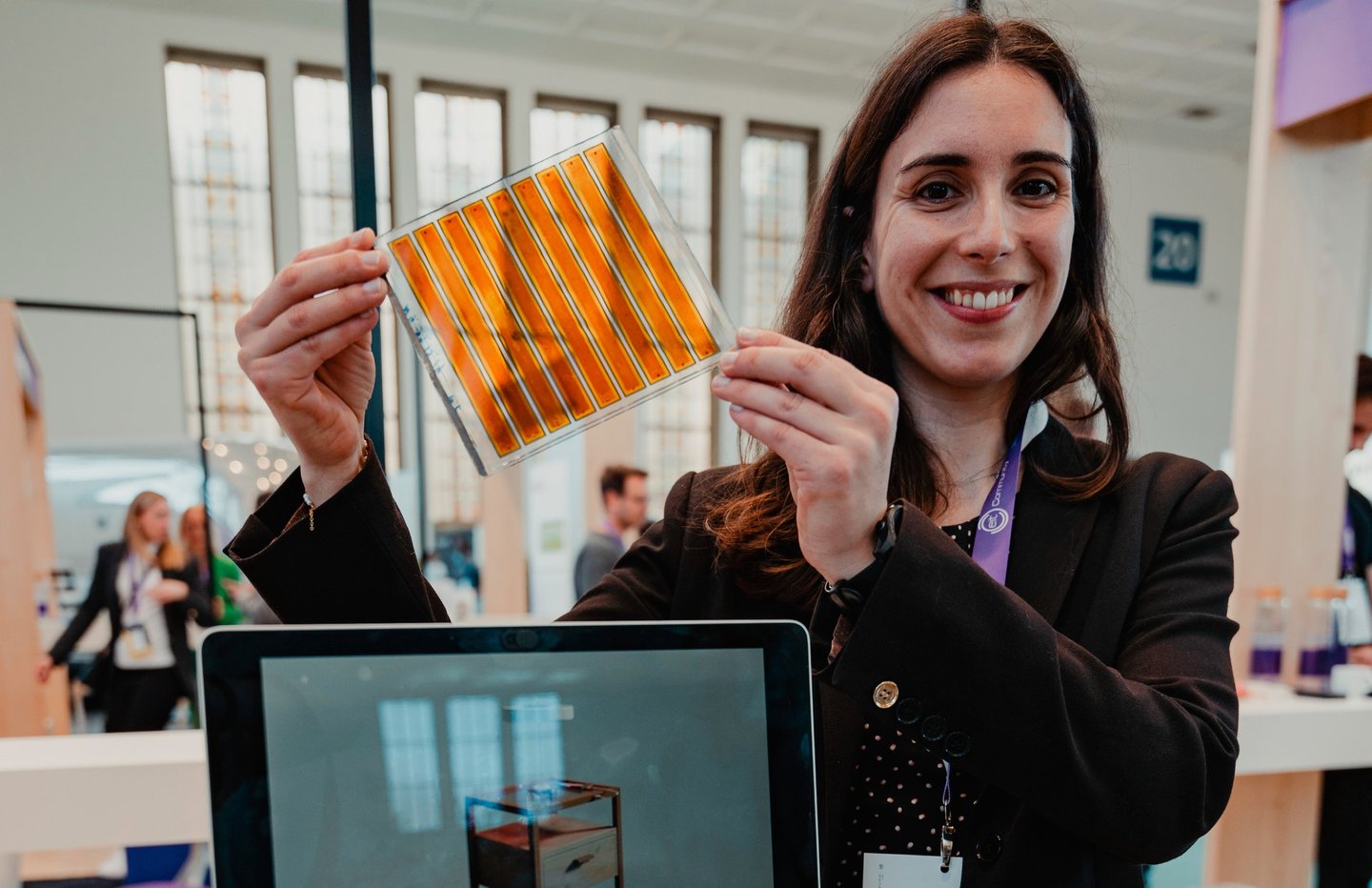 a woman holding a solar pannel (DSSC) - dye sensitized solar cell