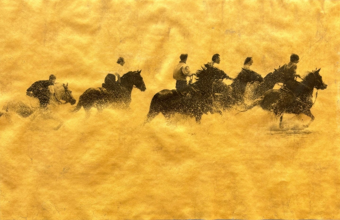 Gold and Platinum photo of a group of people riding horses in the sea