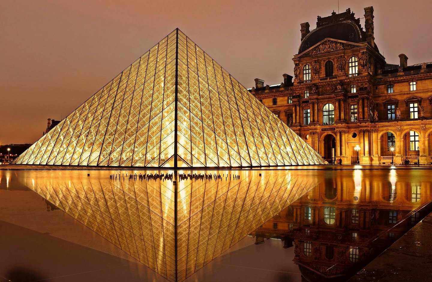 Louvre Museum glass pyramid and palace in Paris France