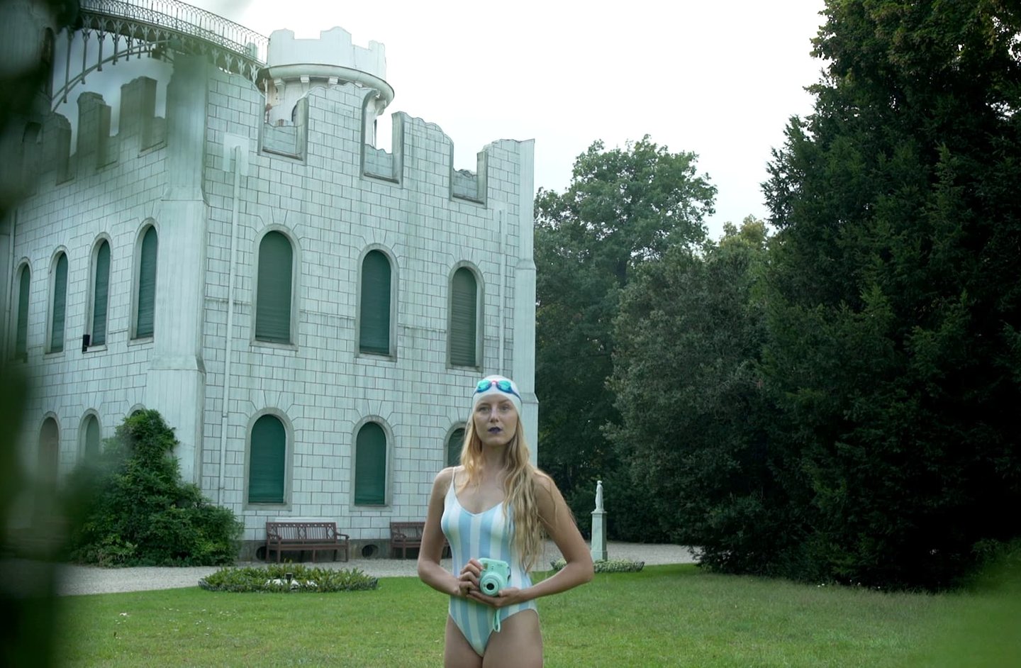 Woman standing in front of a white castle, scene from Nostalgia by Tina Bikic.