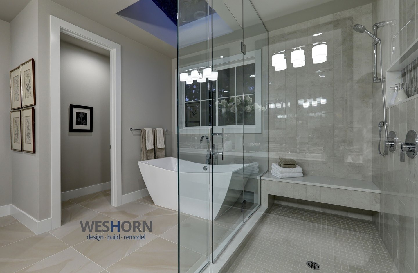 Modern master bathroom featuring a freestanding soaking tub and glass-enclosed walk-in shower with stone tile.