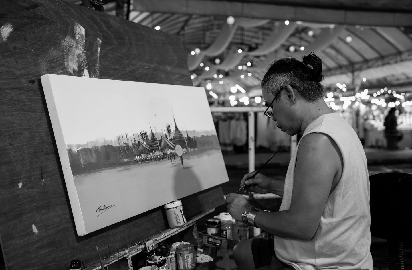 In the old town of Chiang Mai, Thailand, a street performer is at work.