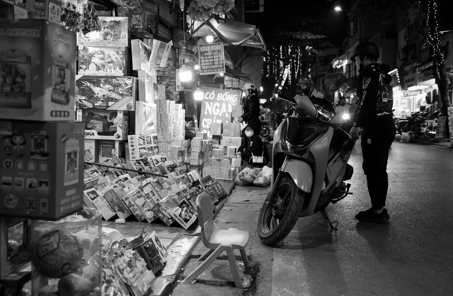 black and white night photography Hanoi light shadow street scene Vietnam
