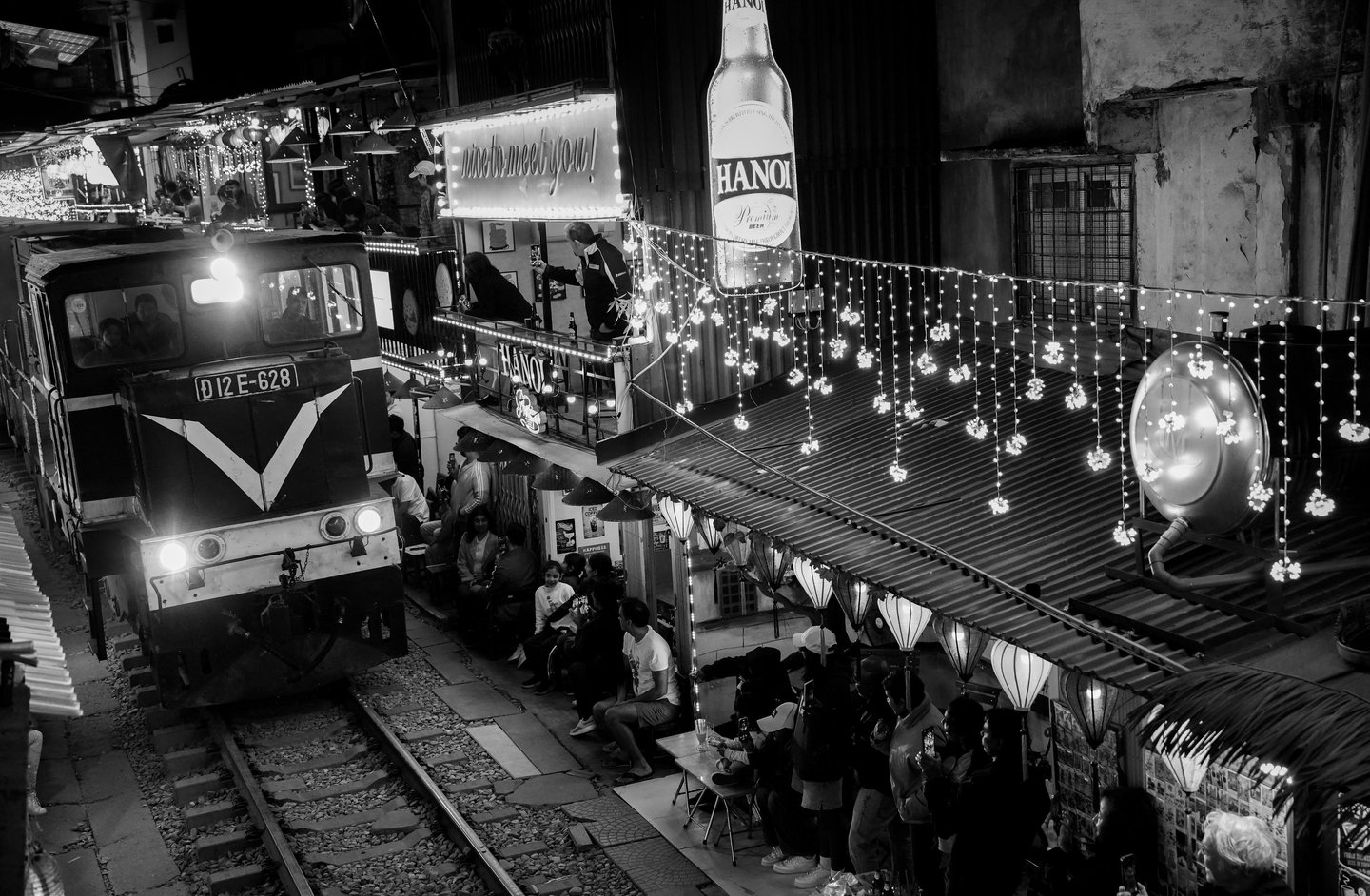 Hanoi Train Street black and white night photography train passing narrow street