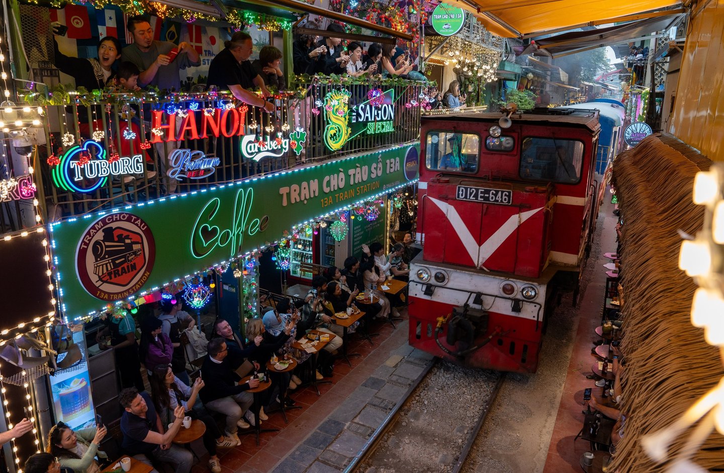 A locomotive pulls into the train street of the Old Quarter, where many bars with visitors are locat
