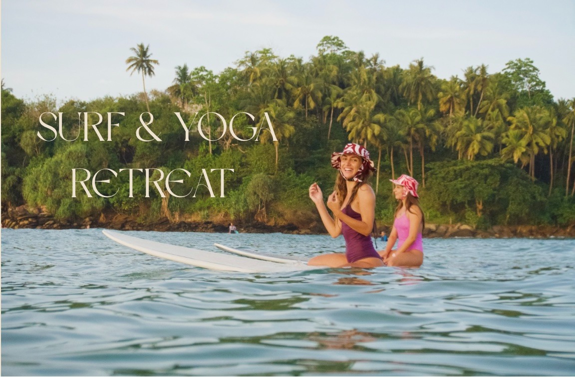 girls sat on surfboards at tropical beach